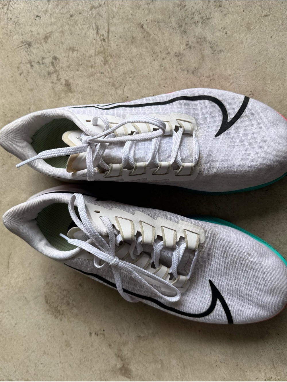 Nike Women’s White Athletic Shoes with Black Swoosh and Teal Accent